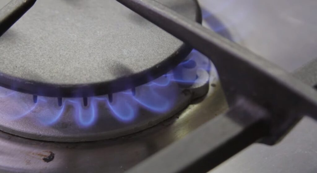gas lit on blue flames on a burner